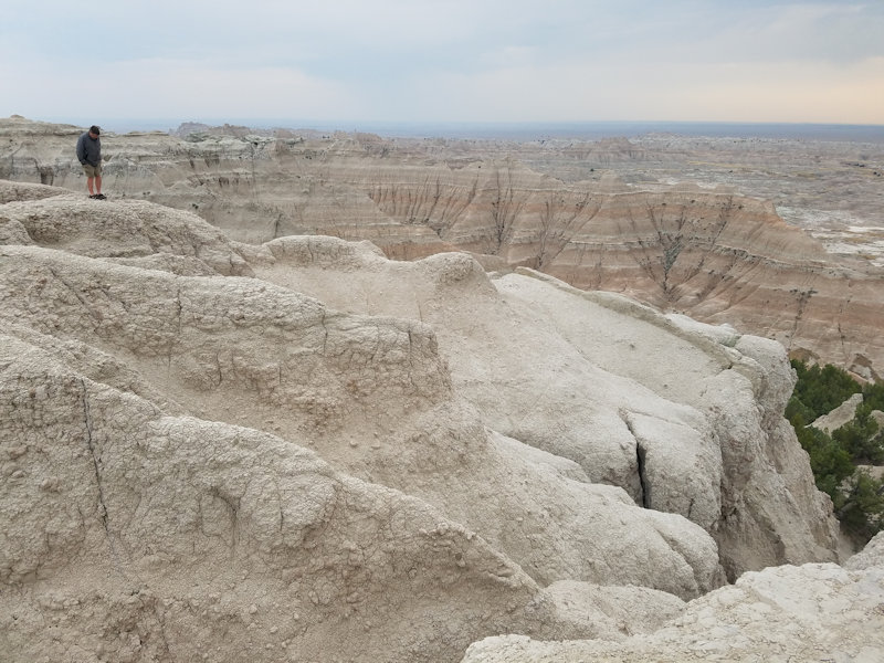 a man stands in a limestone desert